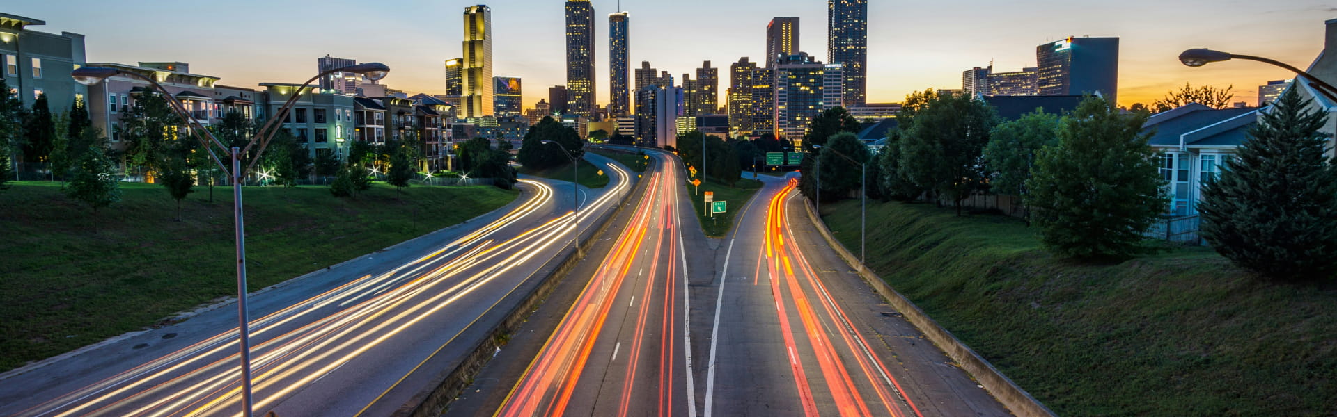 Light trails of vehicles on a road from the airport to the city.