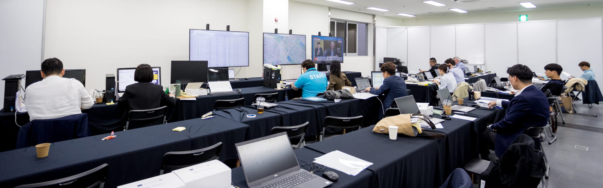 Event staff in a control room monitoring the T Rise Up dashboard and control system, a solution by GroundK.