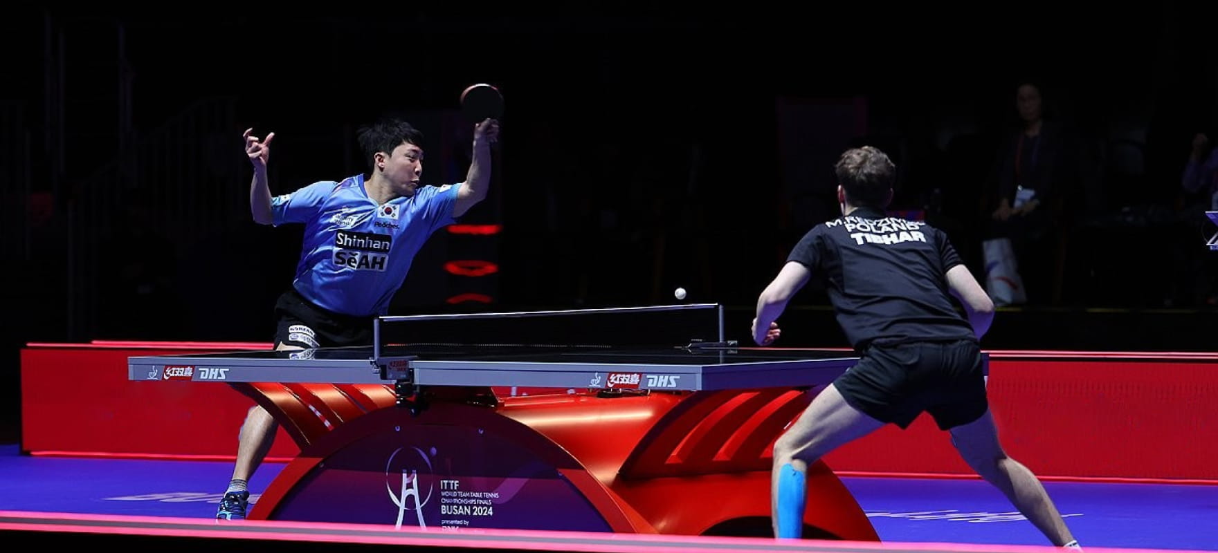 Two table tennis players competing at the 2024 Busan World Table Tennis Championships.