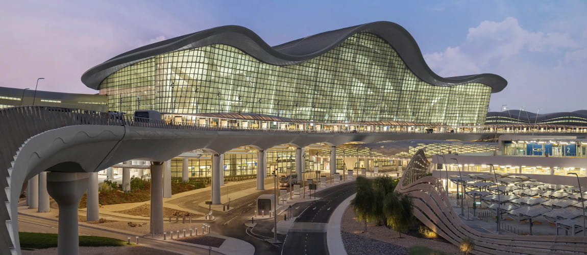 Abu Dhabi’s Midfield Terminal by evening, well-suited for luxury airport services.