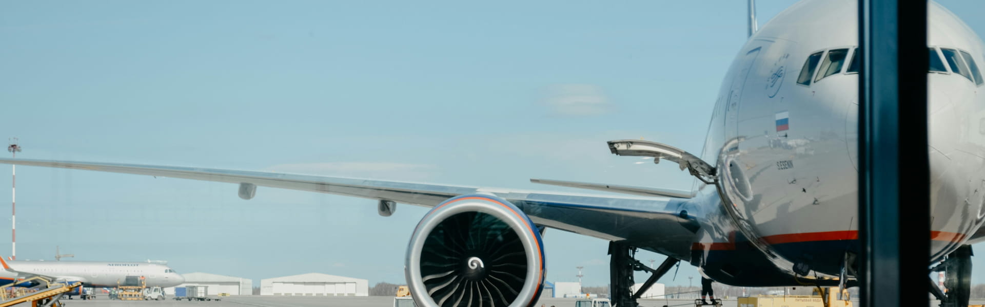 Airplane parked at the airport with its engine and fuselage visible.