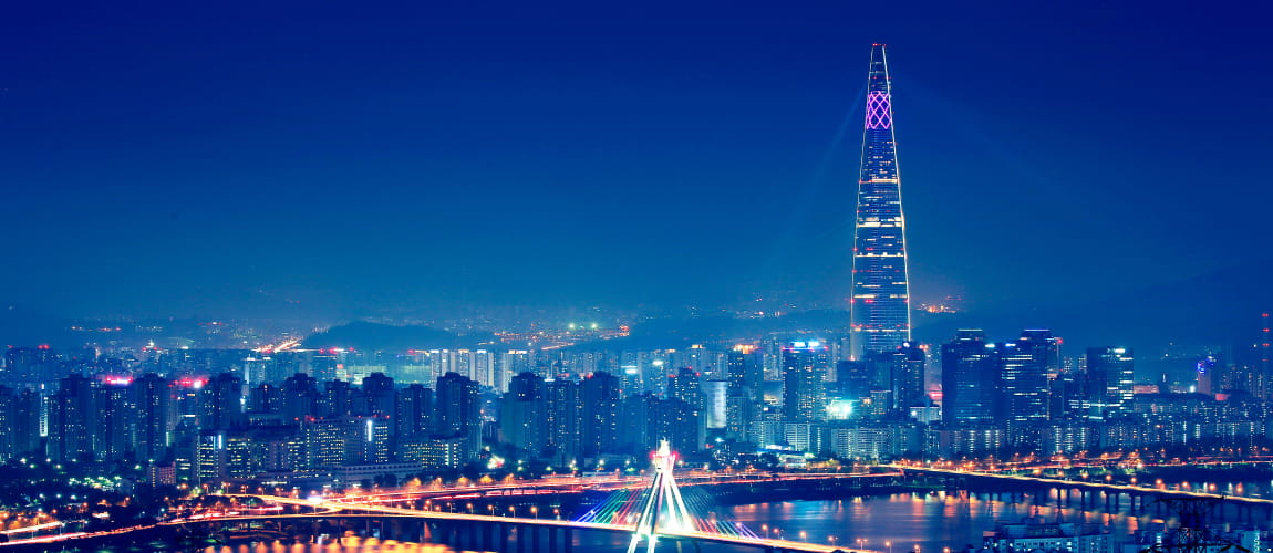 Night view of Seoul city with Lotte World Tower illuminated, showcasing the vibrant cityscape ideal for luxury chauffeur and concierge services.