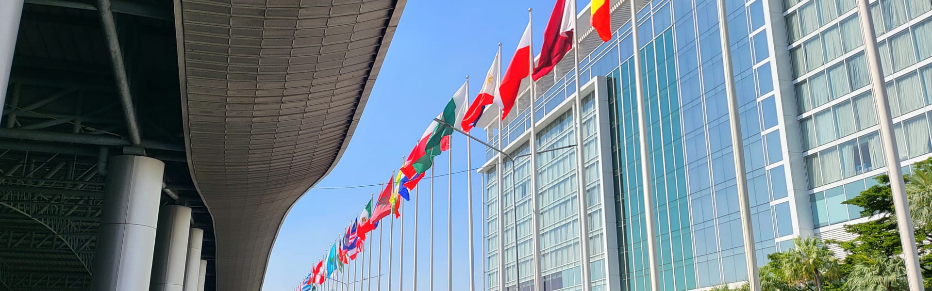 Flags of different countries on flagpoles.