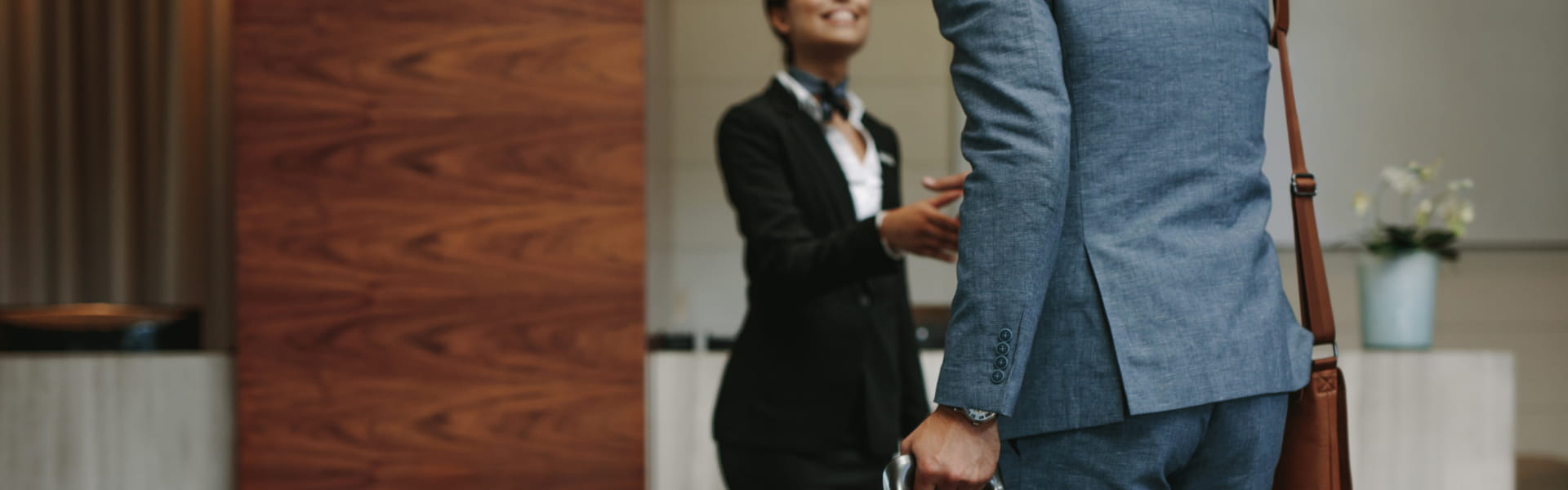 A man and woman in suits shaking hands.