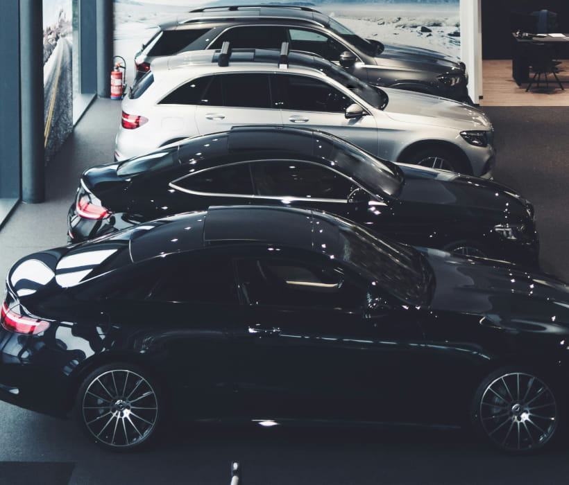 Shiny luxury cars parked in a row.